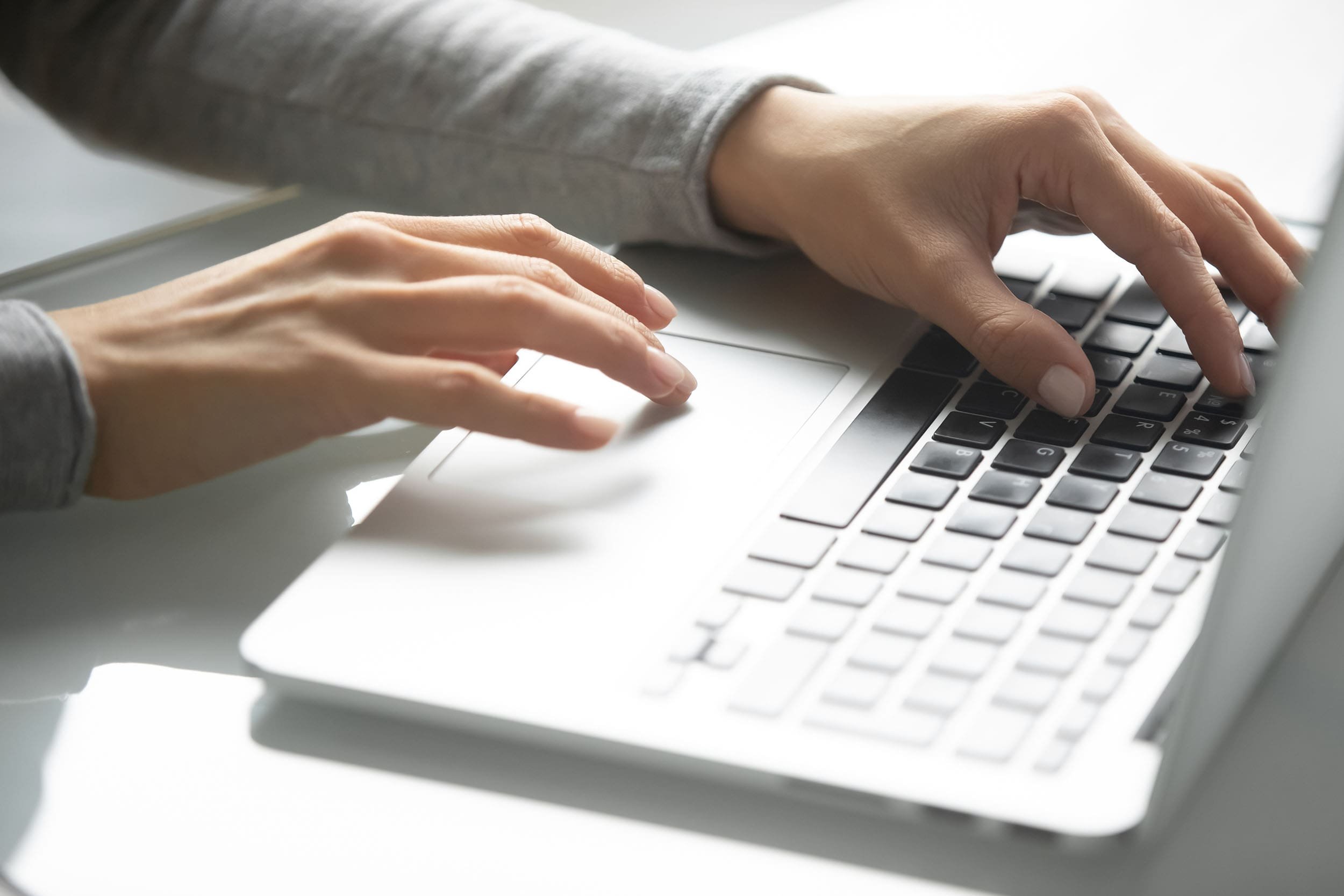 lady with nice nails typing on laptop