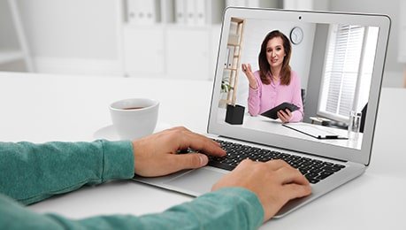 lady in green top in online meeting